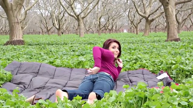 Stripping babe big tits on a green field