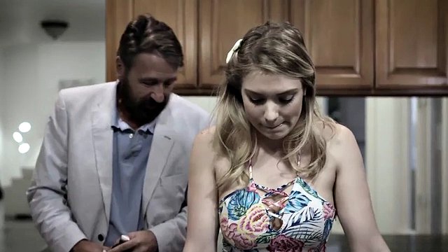Uncle gives his niece a snack in the kitchen