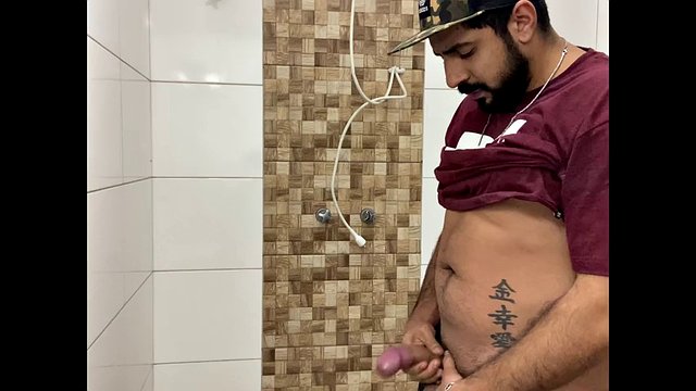 Squirting cum, bearded man with a cap alone in the bathroom having fun in the handjob until he cums a lot - Rodrik Dick