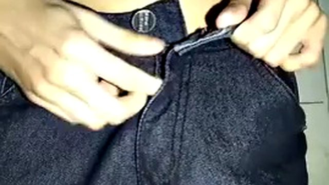 Skinny young man in jeans without underwear pulls down his pants, jerks off his big thick cock and plays with his ass