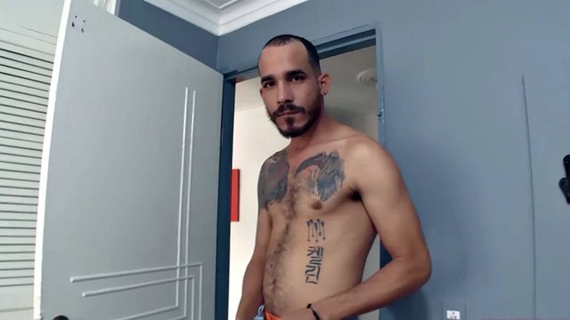 Leon stands in the doorway and starts to get aroused as he undresses. Naked and with a big boner, a horny Latino walks up to the bed and starts jerking off.