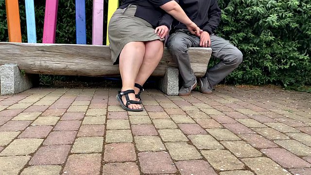 Mother-in-law masturbates her stepson's cock in a public park